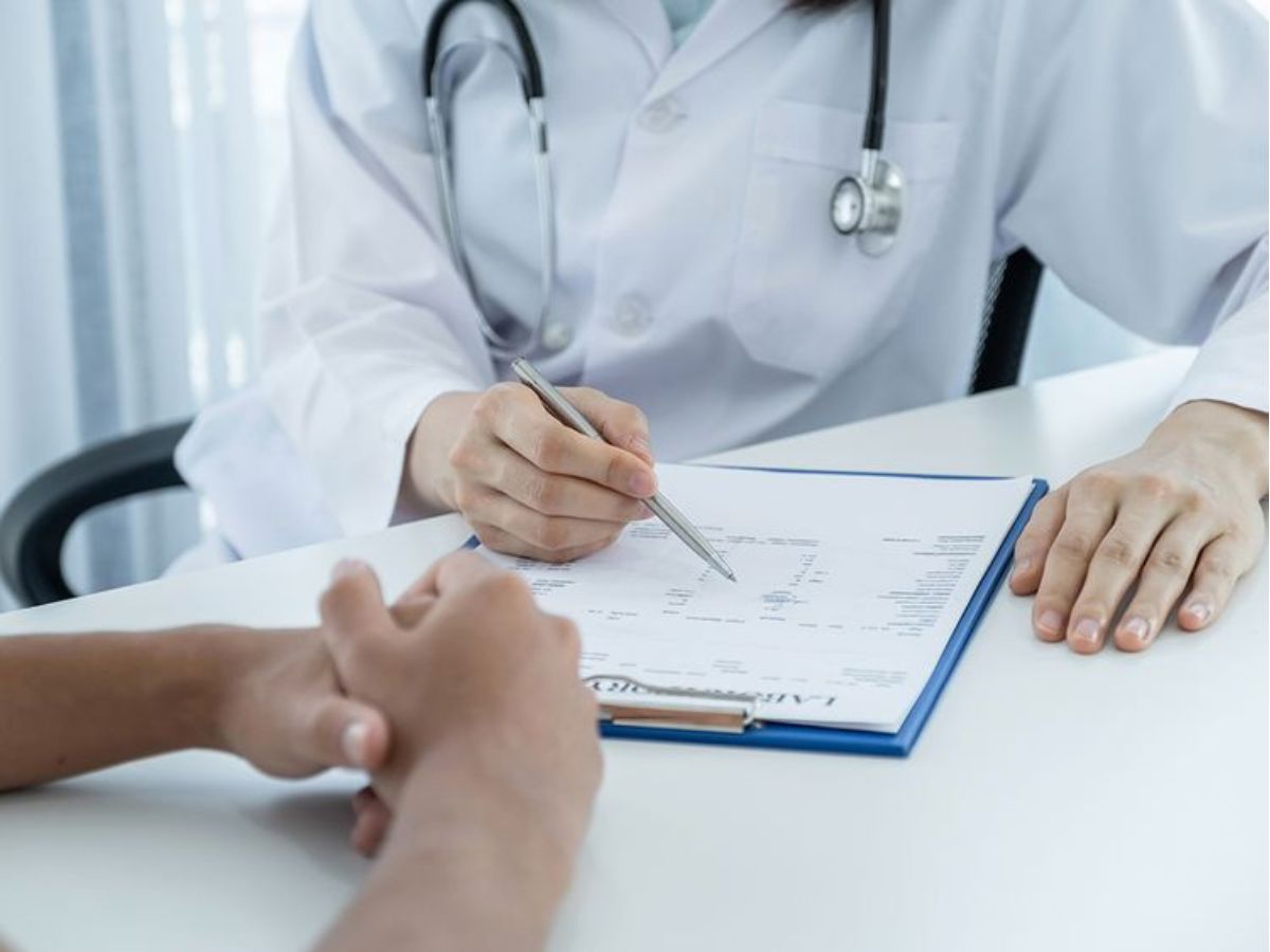 Hands of a doctor during a consult with a patient in a healthcare setting