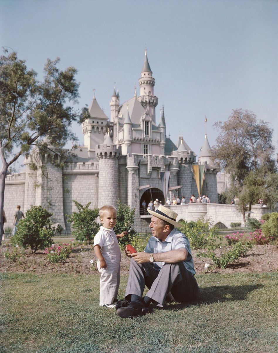 Walt Disney with his grandson in front of Sleeping Beauty Castle